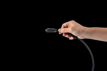 Poster - Hand and VGA cable connector isolated on black background.