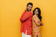 © Drobot Dean - Indian man and woman looking at each other while standing back to back isolated over yellow background