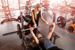 © Olha - Young couple doing barbell exercises in the gym together. Wide angle shooting, top view.