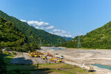 Fototapeta Desenie - Clearing the riverbed in the mountains