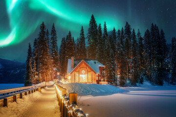 Wall Mural - aurora borealis or northern lights over emerald lake lodge glowing in the night at yoho national par