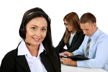 Canvas Print - Businesswoman with Headset and Co-Workers In Background - Isolated