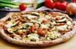 Fresh  homemade vegetarian Pizza, healthy pizza dough with wholemeal flour, sesame  and linseeds, topping with vegetables, mozzarella, hollandaise sauce and cashew nuts