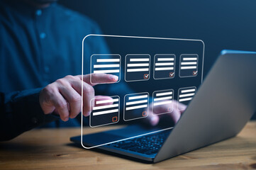 Document management system DMS. Assessment form, questionnaire, checklist and clipboard task management. Businessman working on laptop computer productivity checklist and filling survey form online.