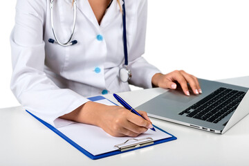 Wall Mural - Closeup of Doctor Writing on Clipboard and Using a Laptop