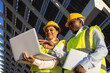 © ADDICTIVE STOCK - Female engineers using laptop on construction site with solar panels