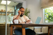 © tonefotografia - Happy African American man wearing casual clothes working in his home