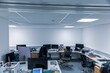 © Louis Reed/Wirestock Creators - Shot of an office environment with desks and chairs with led lighting and white walls