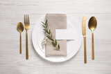 Fototapeta  - Stylish setting with cutlery, eucalyptus leaves and blank card on white wooden table, flat lay. Space for text