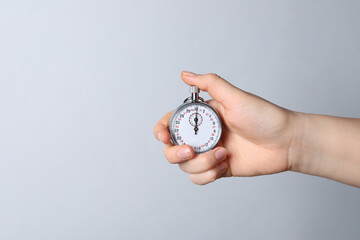 Wall Mural - Woman holding vintage timer on white background, closeup. Space for text