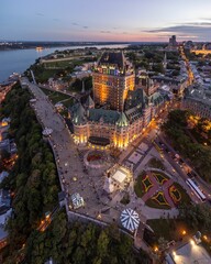 Sticker - Chateau Frontenac in Quebec City lit up at sunset with people walking around