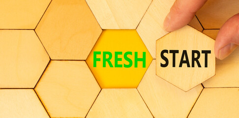 Wall Mural - Fresh start and motivational symbol. Concept words Fresh start on wooden puzzles. Beautiful yellow table yellow background. Businessman hand. Business motivational and Fresh start concept. Copy space.