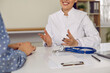 © Studio Romantic - Doctor giving a professional consultation to a patient. Cropped shot of a friendly physician in a white coat sitting at her table and talking to a young woman. Medical concept background