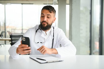 cheerful young arab man doctor having video call with patient