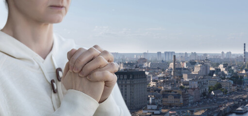Wall Mural - A prays against the backdrop of the city.