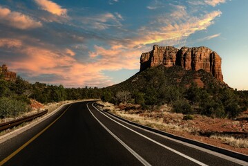 Poster - Beautiful view of a road and a rock formation on the right at sunset in Sedona, Arizona, USA.