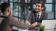 © Katsiaryna - smiling businessman shaking hands with his business partner