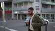 © Marco - One thoughtful young Arab man stands in street wearing jacket. Pensive expression of a Moroccan guy with contemplative face