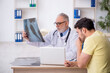 © Elnur - Young male patient visiting old male doctor radiologist