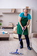 © Elnur - Old male contractor cleaning the house