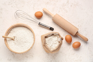 Wall Mural - Composition with wheat flour, eggs, whisk and rolling pin on white grunge table