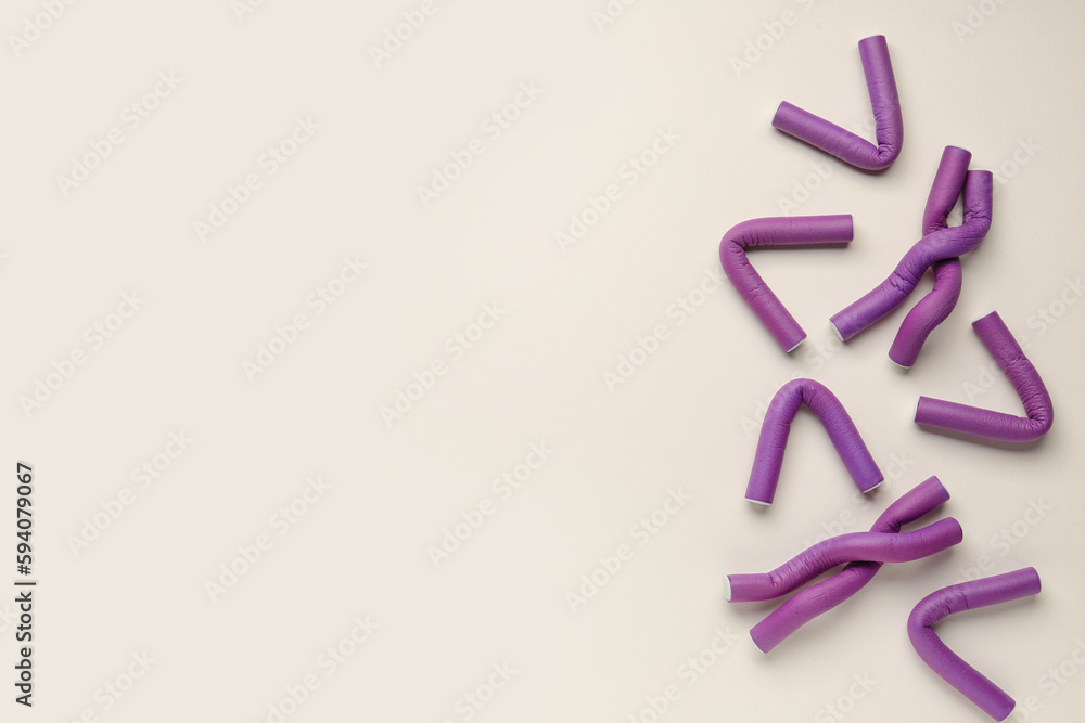 Hair curlers on light background