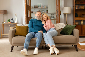 Wall Mural - Loving Senior Couple Embracing Posing In Living Room At Home