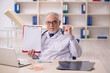 © Elnur - Old male doctor working in the clinic