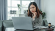 © Phushutter - headache, contemplation, worry, stress, frustrated, Online consulting with laptop in office of asian thai japanese chinese female exclusive lawyer legal advisor, legislation, legal contract documents