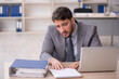 © Elnur - Young male employee working in the office
