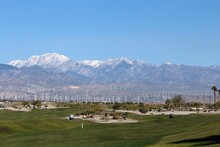A View Of A Beautiful Scenic Landscape On A Sunny Day, With Palm Trees And Huge Mountains In The Background, Where People Come To Golf, In Palm Springs, California, United States