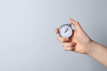 Wall Mural - Woman holding vintage timer on white background, closeup. Space for text