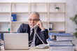 © Elnur - Old male employee and too much work at workplace