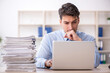 © Elnur - Young male employee and too much work in the office