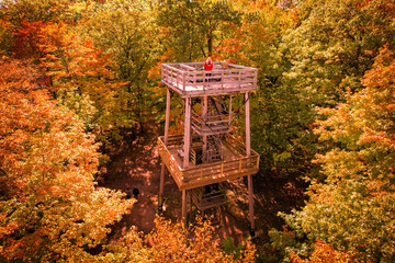 woman in a red jacket on the mountain tower, fall colors