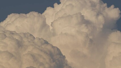 Wall Mural - Cloud closeup Time lapse video. Large, detailed clouds captured from a distance with high-quality cameras and lenses.