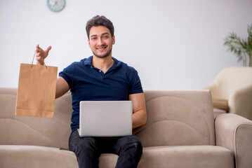 Wall Mural - Young man purchasing goods via Internet