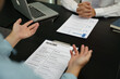 © Charlie's - Team leader coach teach young workers explain on paper for business plan listen talkative coworker and discussing new project presentation Serious professional advisor consulting in office.