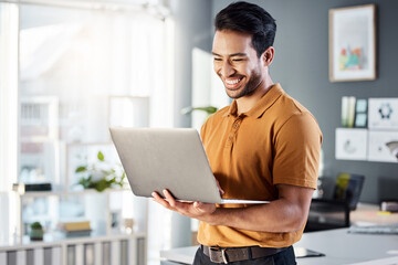 Laptop, office and happy man for online planning, website design and software management at tech company. Creative asian person, designer or employee on computer or technology for web 3.0 review