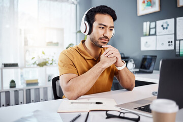 Fototapete - Thinking, laptop and headphones on business man listening to music, audio or webinar. Asian male entrepreneur with technology for planning strategy, idea or reading email or communication on internet