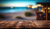 Fototapeta Natura - Empty wooden table and blurred background of beach cafe with bokeh lights
