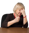 © BillionPhotos.com - Sick Old Woman with Headache Sitting behind Table and Smoking a Pipe - Isolated