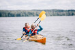 © Photocreo Bednarek - Happy senior active couple kayaking on lake