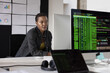 © ReeldealHD images - Young African American female coding at a desktop computer in an office