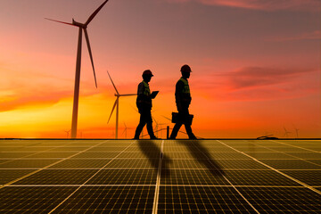 Silhouette engineer working on solar cell plant with windmill field .Solar cell smart grid and windmill are ecology energy renewable sunlight alternative green power environment factory concep.t