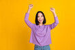 Photo of young korean woman scream wear trendy violet shirt fists up hooray celebrate shopping season isolated on yellow color background
