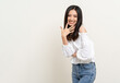 © Chanakon - Beautiful smiling happy young asian woman age around 25 in white shirt. Charming female lady standing pose on isolated white background. Asian cute people looking camera confident with backdrop.