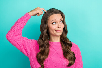 Wall Mural - Photo of doubtful unsure girl wear pink sweater finger head looking empty space isolated turquoise color background