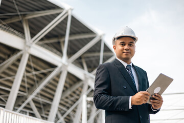 Businessman manager owner real estate working with digital tablet at modern office building. Cooperation of architect designer. Engineer with safety helmet checking at working construction site