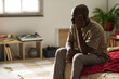 © pressmaster - African American young man in depression sitting alone in his bedroom
